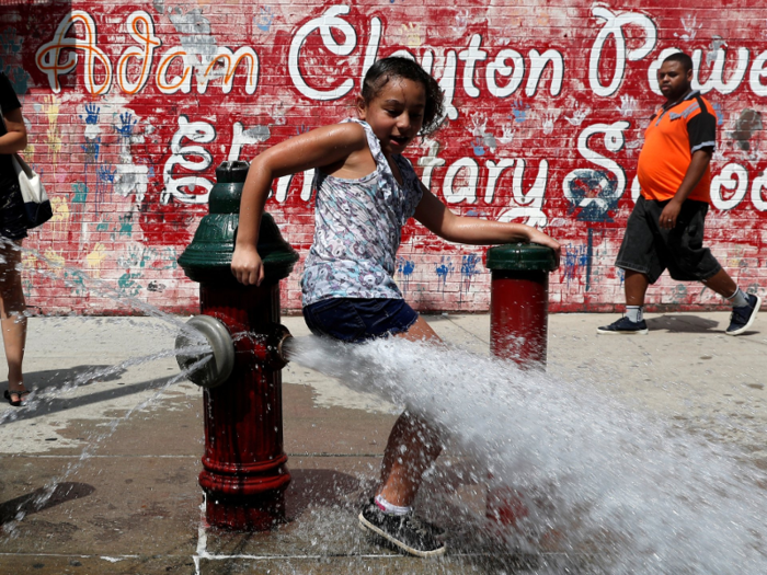 In Washington Heights, New York, fire hydrants are harnessed to keep cool.