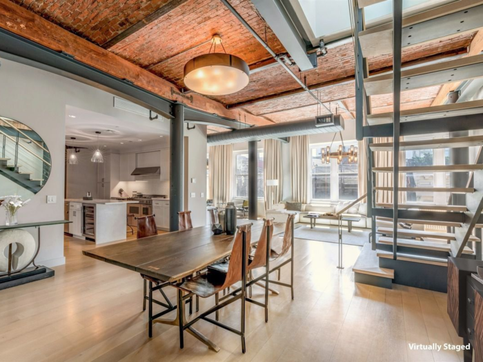 Preserving its historic roots through architecture, the post-industrial style home boasts 12-foot-high vault ceilings and a custom steel staircase.