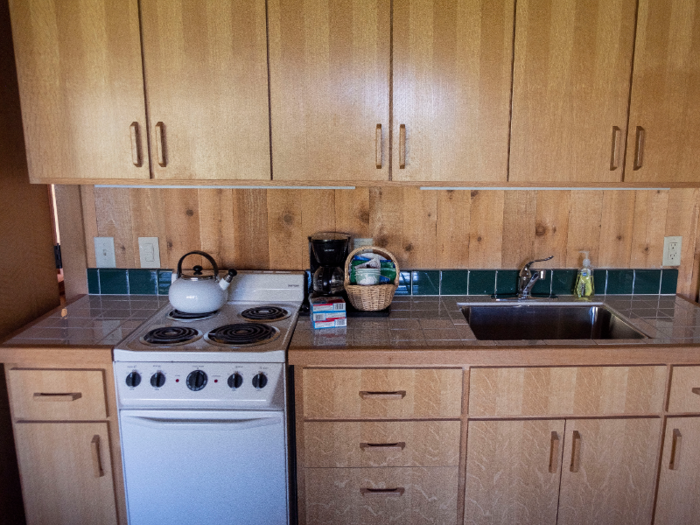 The kitchenette includes a four-burner stove, an oven, and a coffee maker.