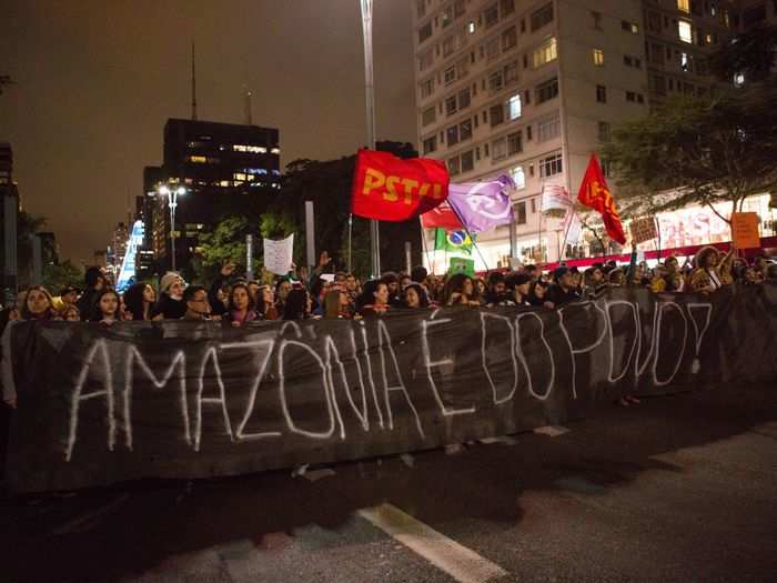 A big group of people who were shouting words to protect the rainforest and against Bolsonaro carried a banner that read, "Amazônia is from the people!"