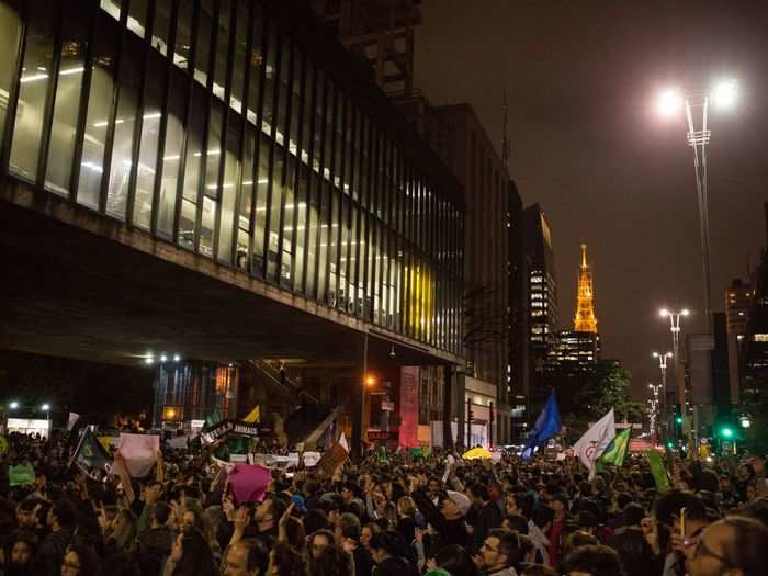 The avenue filled up with people waving flags, signs, and banners.