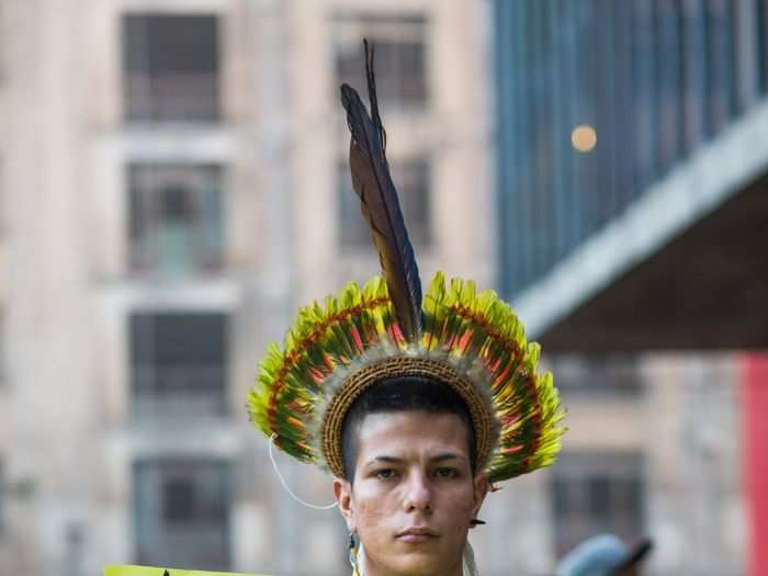 A young man held up a quote from Chief Seattle, a leader of the Suquamish and Duwamish tribes in the 1800s: "The Earth does not belong to man, man belongs to the Earth." The chief is the namesake for Seattle, Washington.