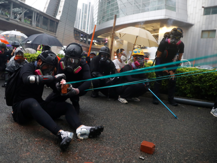  Protesters threw at least six petrol bombs, sprayed detergent on roads to make them slippery for police, and threw bricks. 