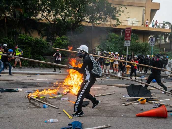  Protesters reportedly dismantled some poles with saws and ropes, shutting down streets and wielding slingshots, poles, iron bars, and bricks in a fight with police. 