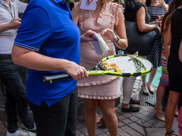 One intrepid server was offering up snacks on a tennis racket, which seemed to be a bold move.