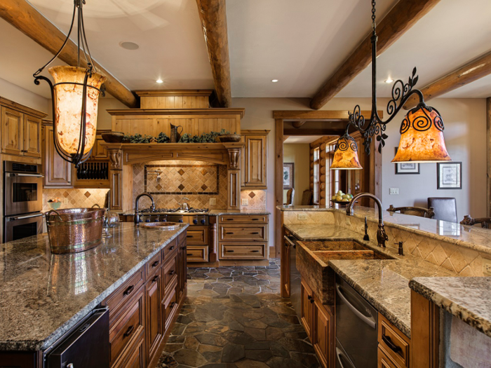 The modernized kitchen and formal dining room lead into the breakfast area, which also has access to a balcony with views of Juniper Creek and property.