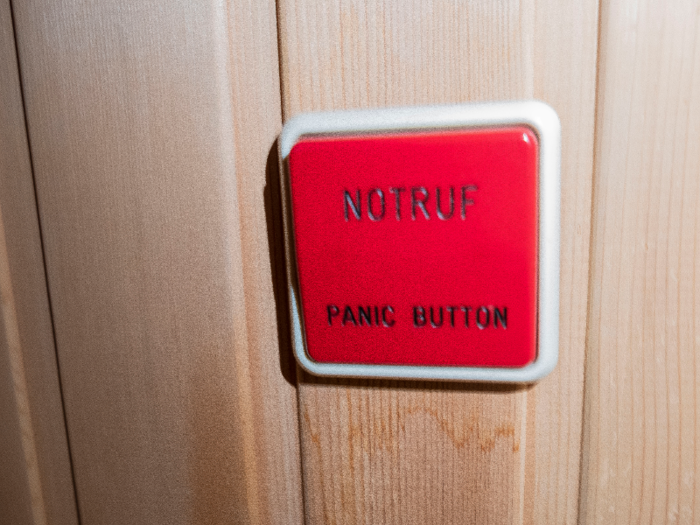 Just inside the door to the sauna is a large red button that you would think, looking at this picture, could not be missed.