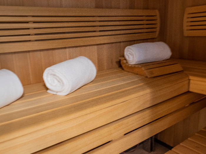 The sauna is small, but three or four people could probably fit if they got cozy.