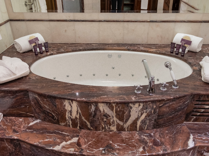 The standout feature in the bathroom is the jetted soaking tub sunken into a massive chunk of marble.