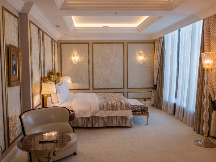 The bedroom is lavishly decorated in gold tones.