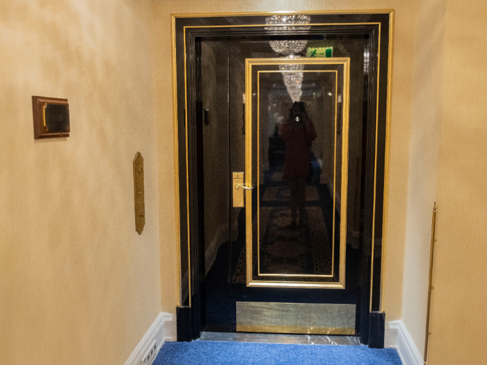 At the end of the hallway was a shiny black door with gold detailing, and a brass plaque with my room number: 1101.