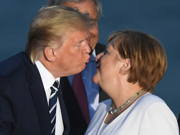 Trump air-kissed Merkel just before a group photo.