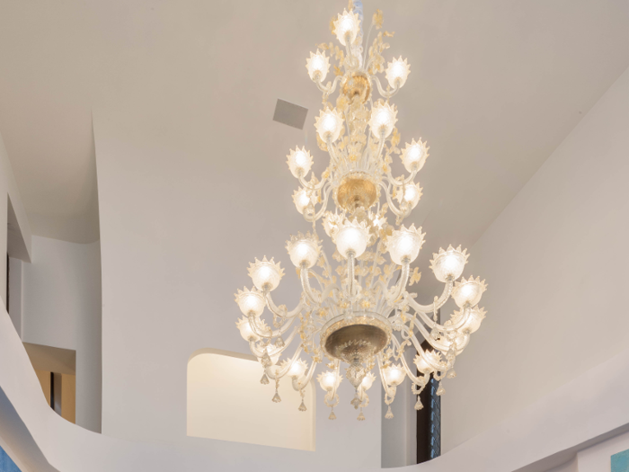 There are several elaborate glass chandeliers throughout the high-ceilinged space.