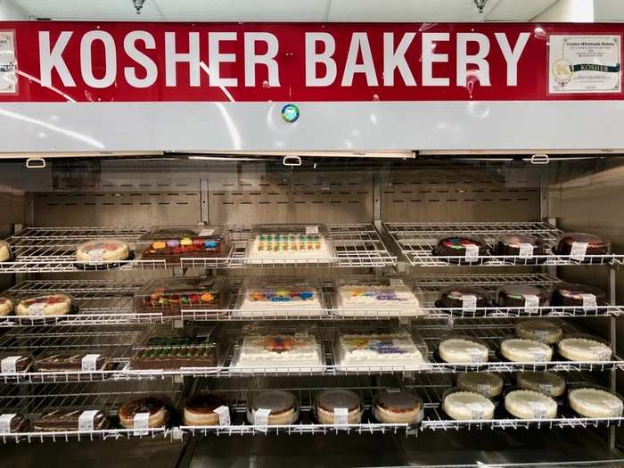 Costco also had a widely stocked bakery, where shoppers could pick up different cakes and pastries. Another flashy sign proclaimed that the baked goods were kosher as well.