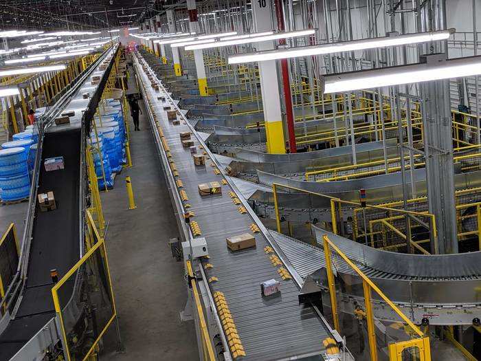 The shipping area seen here was one of the most immediately impressive parts of the facility. Packages are automatically whisked from the conveyor belt to different chutes solely by the metal slats moving from left to right (the yellow bumps are enough to nudge them off).