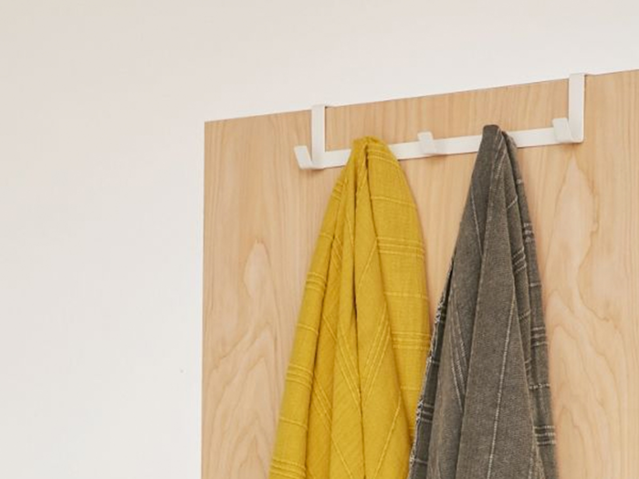 An over-the-door hook that can function in the bathroom or closet for extra storage