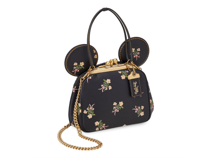 A floral purse with a long chair or top handles