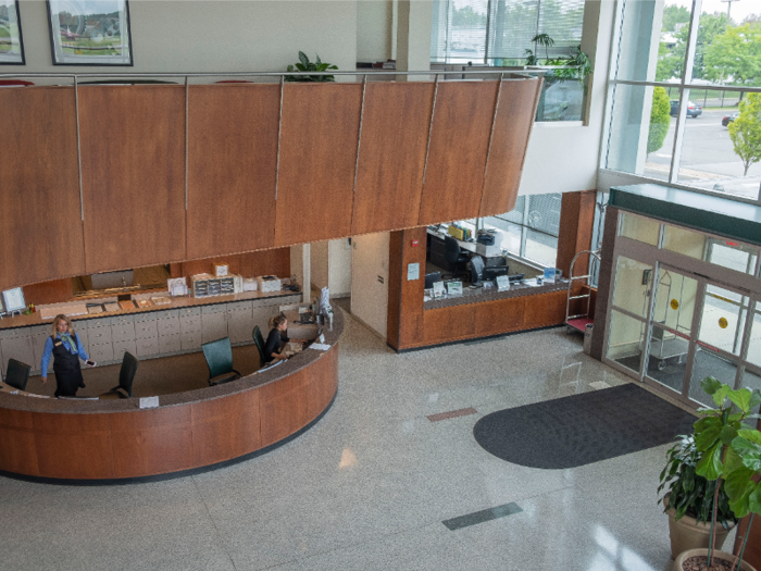 The lobby is airy and bright, with high ceilings and walls of glass.