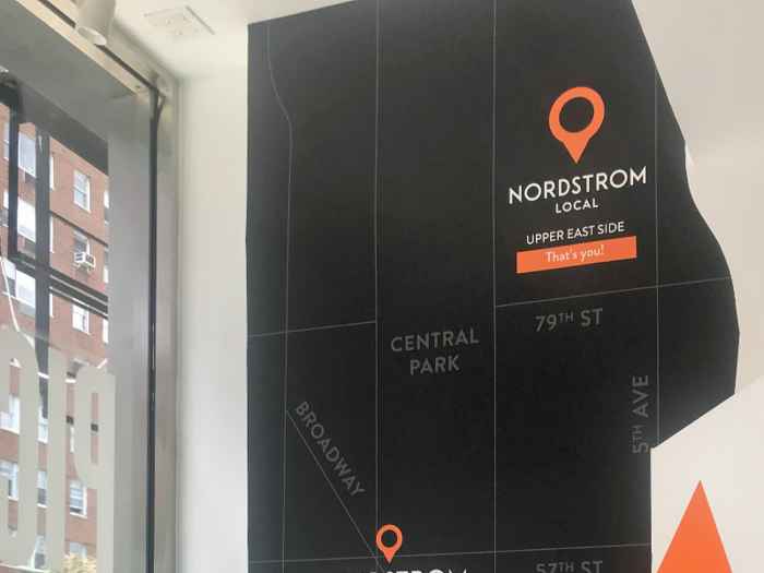 On the wall is a mural of Manhattan that spotlights Nordstrom locations like the Nordstrom men