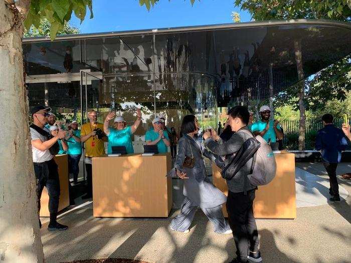 Apple staff members cheer as attendees check in and receive their badges.