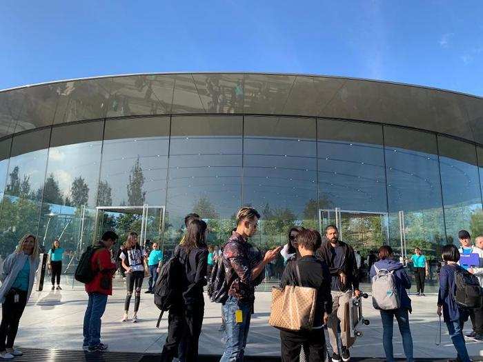 Attendees gather in front of the entrance of the Steve Jobs Theater.