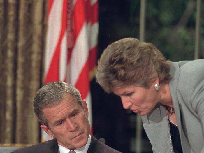 Bush reviews notes with Karen Hughes before addressing the nation from the Oval Office.