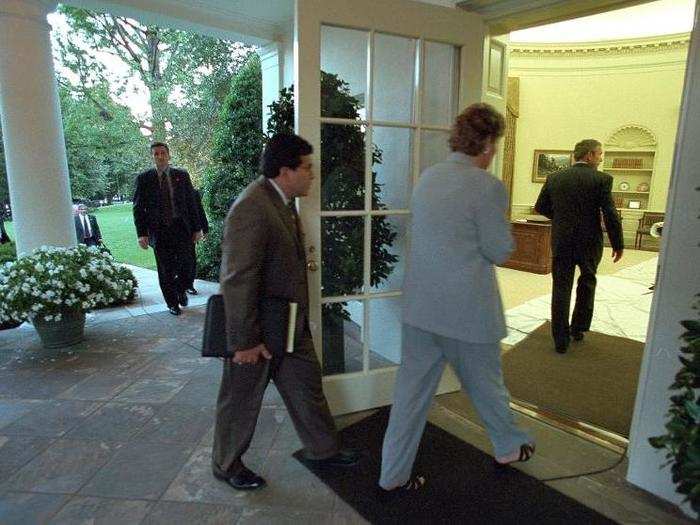 Counselor Karen Hughes and counsel Alberto Gonzales follow Bush into the Oval Office after his return to the White House.