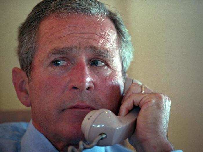 Bush talks with his staff by telephone from his office aboard Air Force One, during the flight from Sarasota to Barksdale Air Force Base in Louisiana.