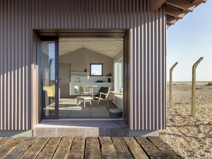 The timber sheds were redesigned by UK-based designer Johnson Naylor into a one-bedroom beach vacation rental home in 2018.