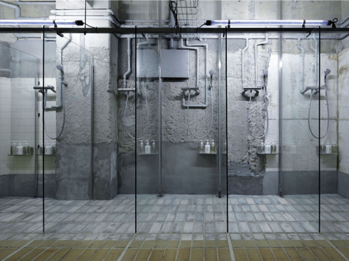 A public bath in the basement was transformed into showers and a sauna. Existing interior finishes were stripped and reconstructed to provide for a more unfinished look.