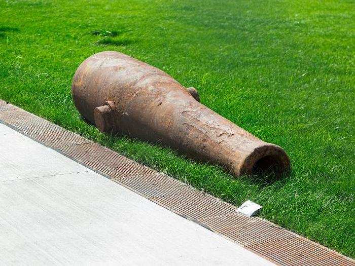 A cannon, found during excavation, is used as a decorative accent in space outside the building.