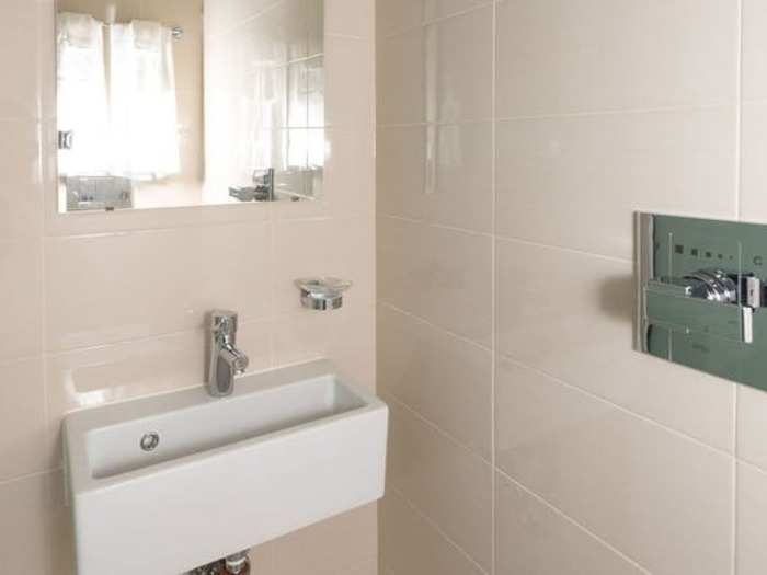 The small sink within the shower makes use of every square foot of available space.