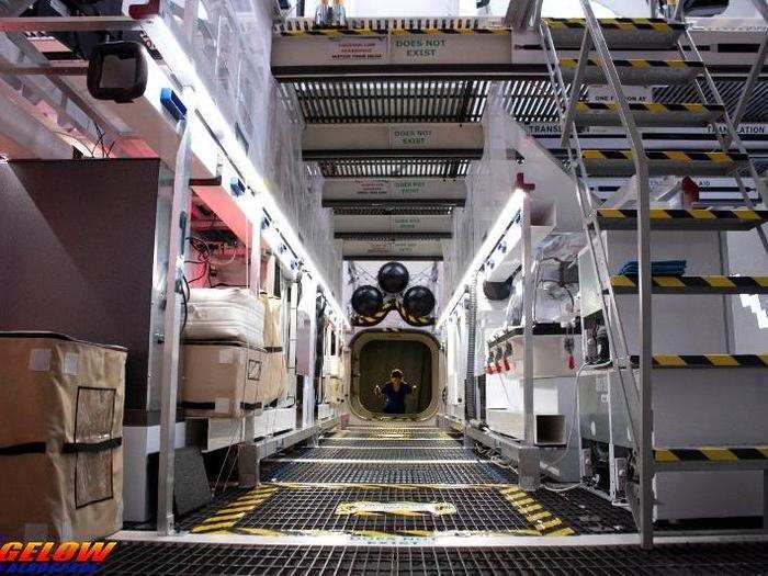 The hatch leads into the central core of the B330, which Bigelow envisions as packed with cargo prior to launch. Cold storage for food, research, and other supplies is also on the middle deck.