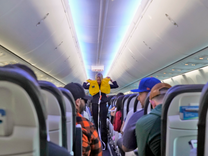 By the time I was settled, a flight attendant was already demonstrating emergency safety procedures.