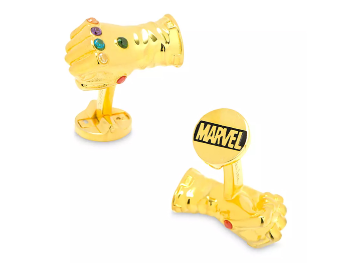 A pair of gleaming gold cufflinks à la Thanos