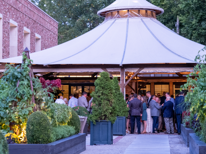 Outside, a cocktail and buffet area was covered by a large tent and surrounded by a garden.