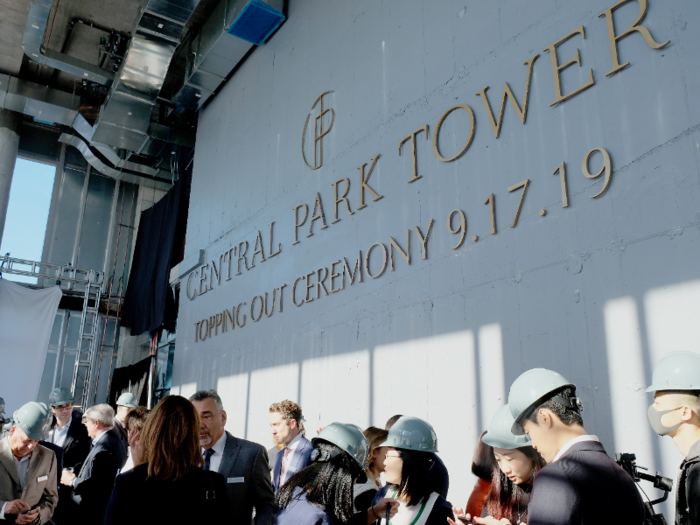 We stepped out onto the 107th floor, where media and Extell employees in hard hats were milling around and enjoying a spread of coffee, juice, bagels, and pastries.