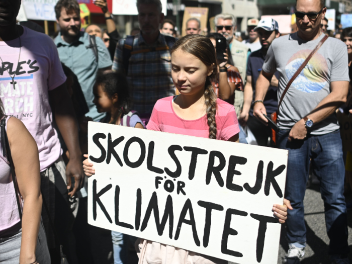 Then she brought out her hand-painted sign, which says "School strike for climate" in Swedish.