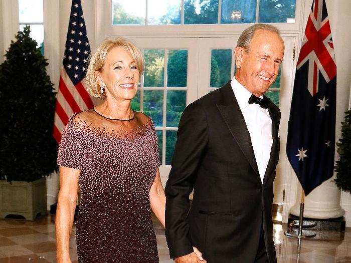 Education Secretary Betsy DeVos arrived with her husband Richard. She wore a $5,500 Pamela Roland pearl-embroidered gown.