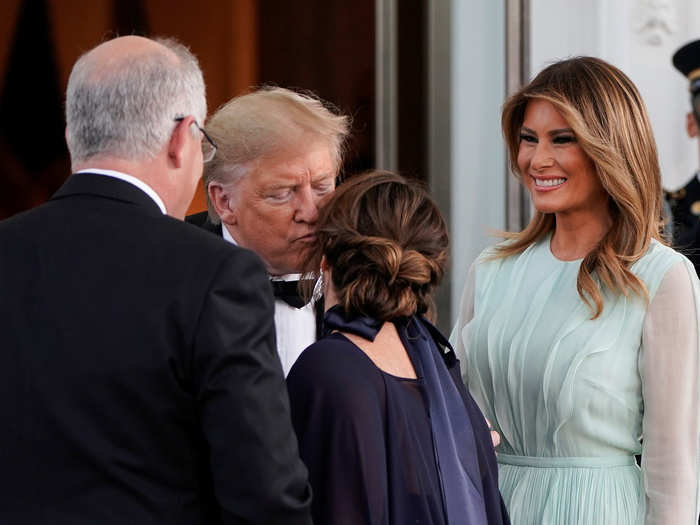 The dress code is formal black tie. The first lady was wearing a $6,000 aqua silk chiffon J. Mendel gown with "bias-cut wave ruffles."