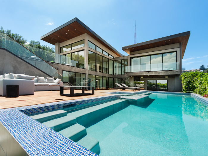 Amenities in the home include an infinity-edge pool and spa ...