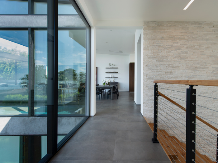 Glass walls throughout the home show off views of both the mountains and the city.