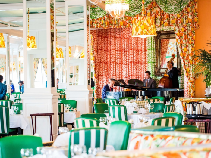 Inside the hotel, the main dining room sports patterned curtains and green-and-white striped seats. Both the common areas and the guest rooms boast similarly lavish designs.