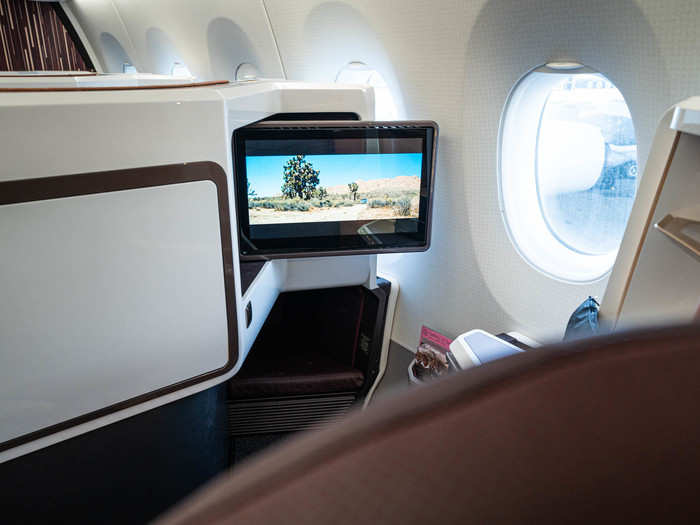 The in-flight entertainment screens are stowed for takeoff and landing, but pop out and can be adjusted to your preferred angle