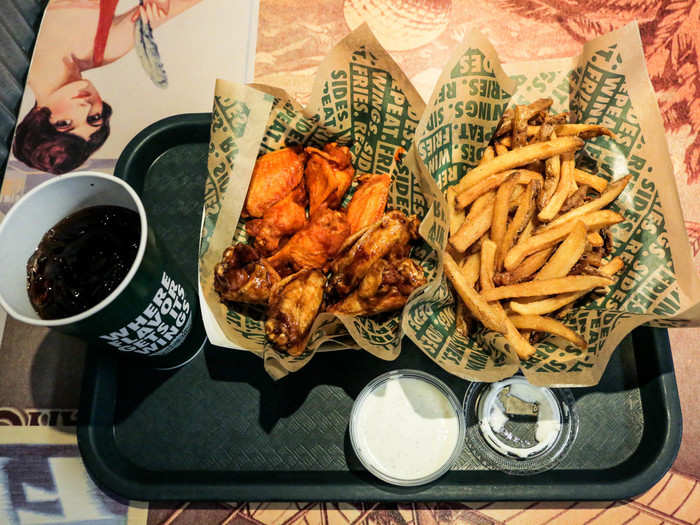 WINGSTOP — I went to the Wingstop in downtown Brooklyn, where a 10-piece order of bone-in wings costs $14.99. This is a combo, though, and includes two flavors of wings, a side of fries, and a fountain drink.