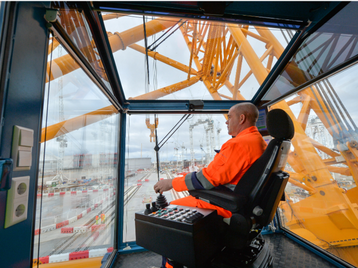 The crane is being used to install concrete, steel structures, and reactor equipment for the power station