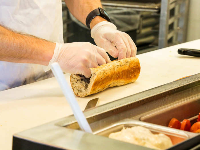 My sandwich artist cut me a fresh length of bread and sliced it open.