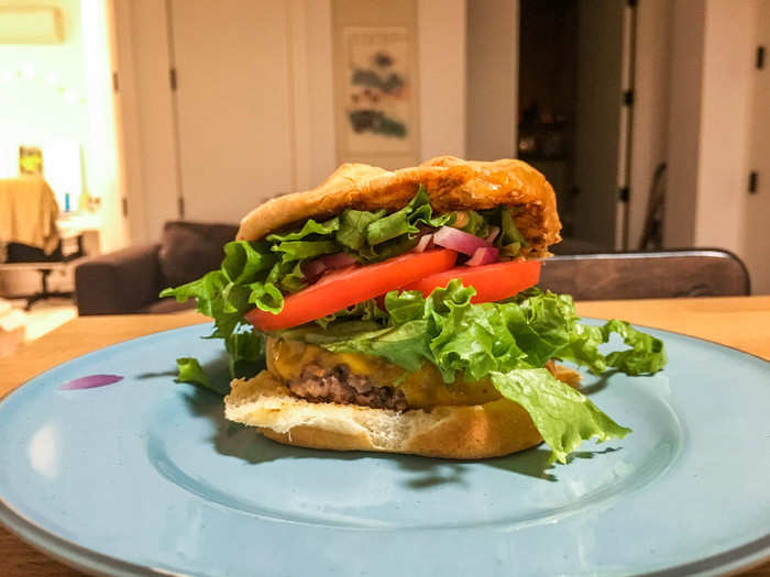 I put the burger on a bun and topped it with lettuce, tomato, and onion, then more lettuce. Maybe a little too much lettuce. Oh well. I squirted a bit of sauce on top to glue it all together.