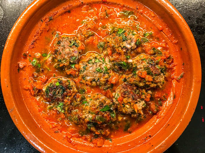 Once they were browned, I plopped them into the tagine, where the tomato sauce base had been simmering all along.