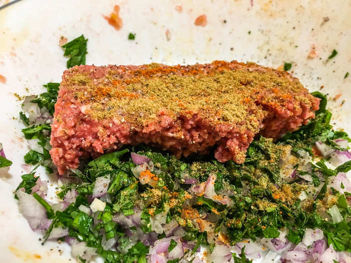 In the meatballs: diced onion, chopped parsley, salt, black pepper, cayenne pepper, and a heaping dose of cumin.